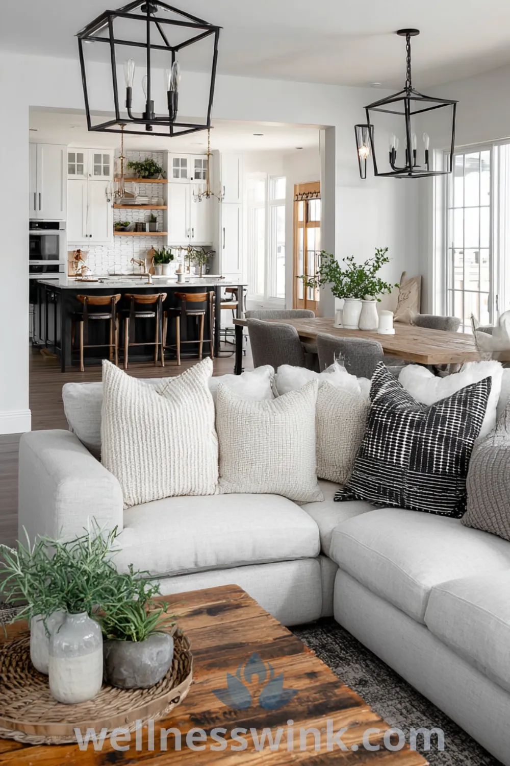 Modern farmhouse living room decor with oversized sectional sofa, reclaimed wood dining table, and chic farmhouse lighting.
